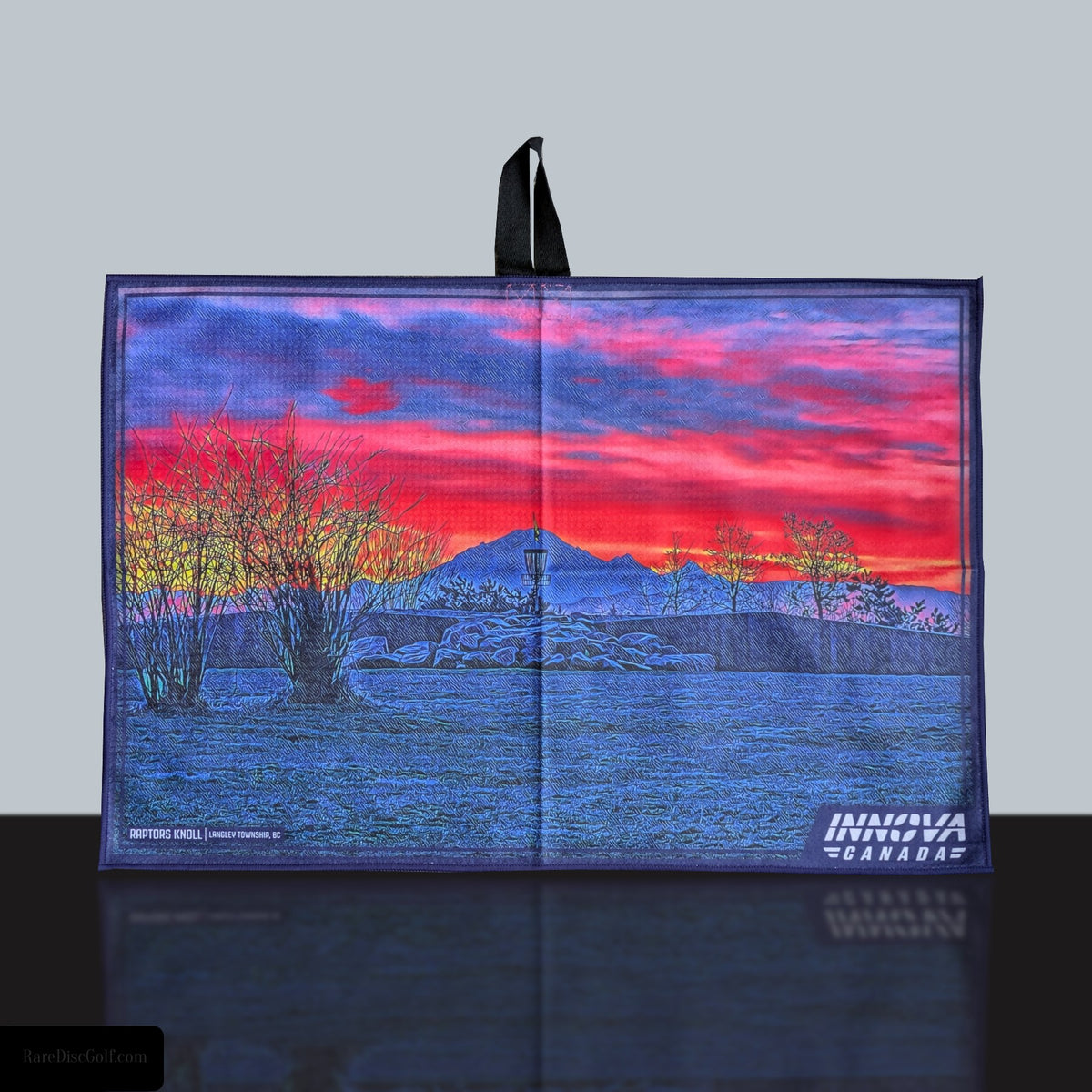 a disc golf towel featuring raptor's knoll sunrise